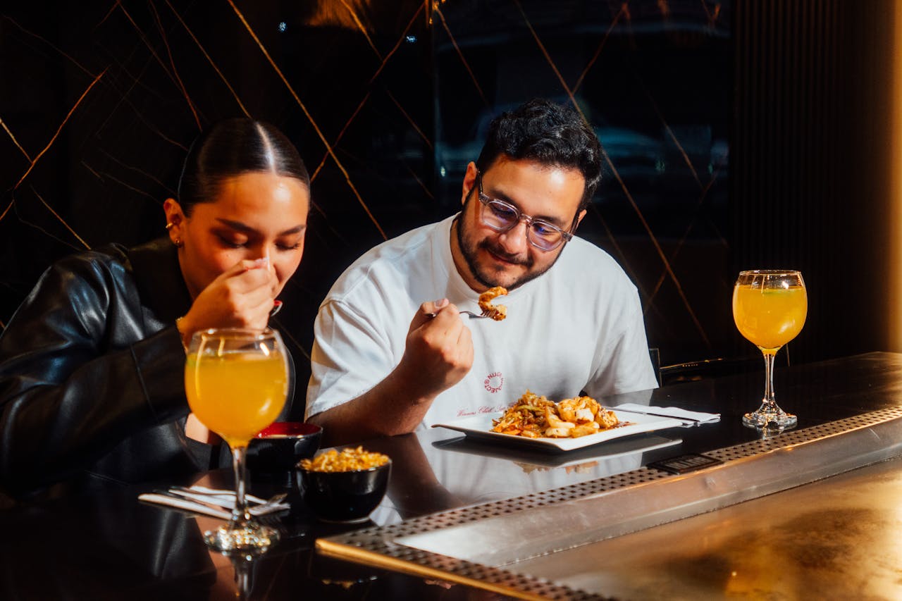 A couple dining at a hibachi grill, enjoying gourmet cuisine.